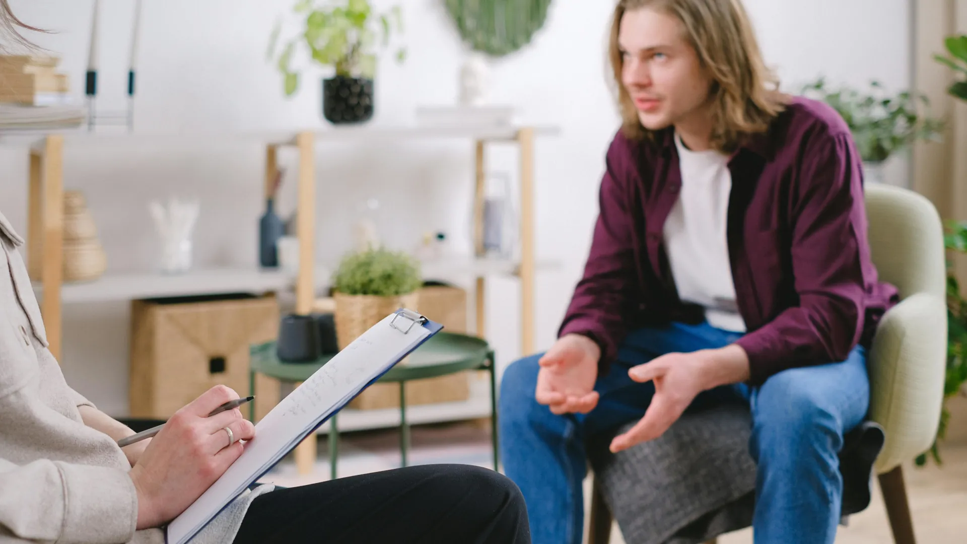 A young teenage boy is discussing his feelings with a counsellor.