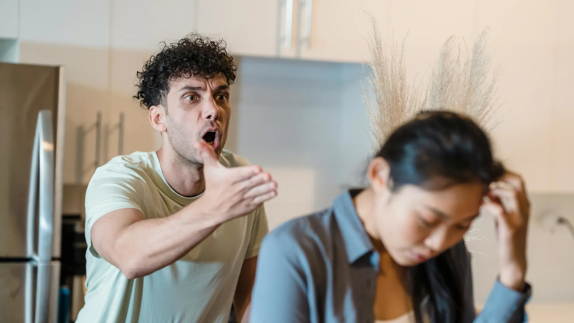 A male is unnecessarily shouting at his partner who appears upset.